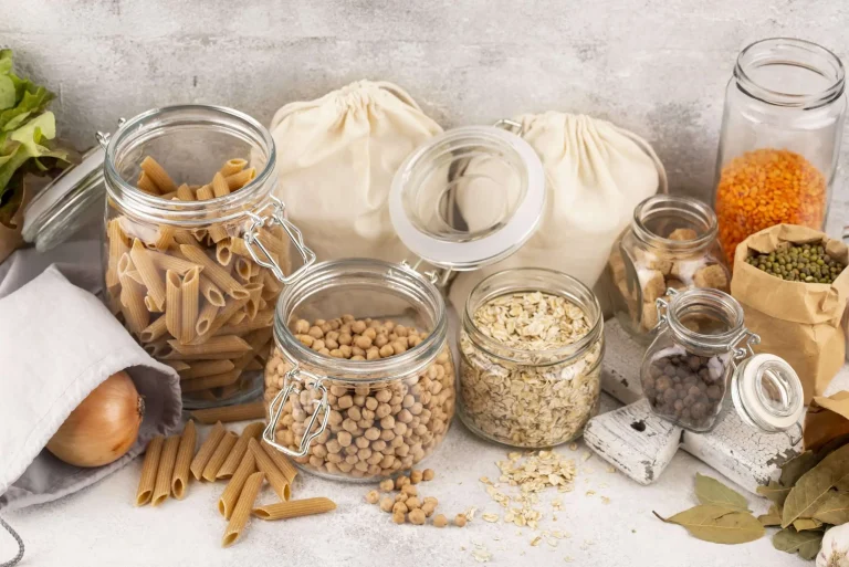 Whole grain pasta, oats, chickpeas, lentils, and other pantry staples arranged for affordable healthy meals.