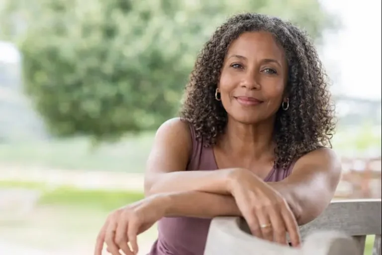 Woman of color in her 40s or 50s with calm expression, representing acne changes during menopause