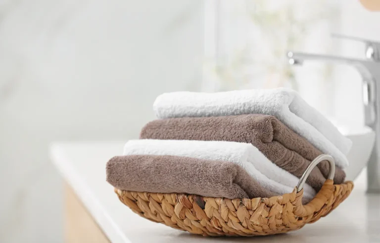 Woman gently patting freshly cleansed skin with a clean disposable face towel